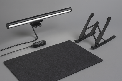 Black desk setup with a mat, lamp, and adjustable stand on a gray background